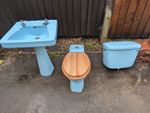 Reclaimed retro 1960s pastel blue ceramic toilet and sink.