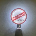 Brand New Red Stripe Beer Badge! Red Stripe Pump Badge! Frog Eye Lens