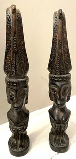 A pair of vintage carved wooden male & female statues - probably Nias island