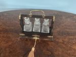 A QUALITY MINIATURE ANTIQUE OAK CASED,THREE BOTTLE TANTALUS  CIRCA-1883.