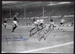 1966 WORLD CUP POSTCARD SHOWING MARTIN PETERS GOAL HANDSIGNED BY THREE PLAYERS