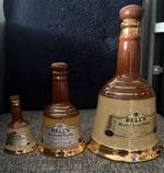 A graduated set of three Bell's Blended Scotch Whisky ceramic bell decanters.