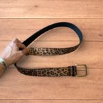 Vintage style faux leather western leopard cowboy belt with bronze trim.