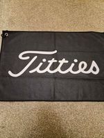 Novelty golf ball towel with clip says Titties instead of Titleist