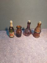 Four miniature glass bottles 'Ball & Claw'/ 'genie'/ De Castellane / amber glass