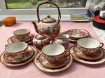 A Japanese Eggshell Porcelain Tea Set with Hand-Painted Geisha Scenes with Gilt.