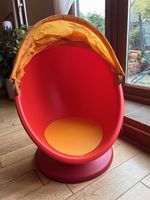 Red and orange IKEA LÖMSK swivel egg chair 
