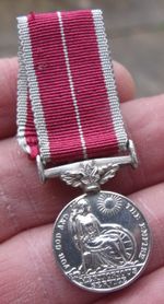 A PERIOD MINIATURE GEORGE VI BEM BRITISH EMPIRE MEDAL, MILITARY RIBBON.