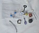A collection of assorted costume jewellery, hat pins and badges