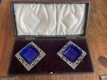 CASED PAIR OF EDWARDIAN STERLING SILVER OPEN SALTS WITH BLUE GLASS LINERS..