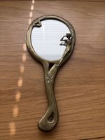 Vintage brass hand mirror Art Nouveau style, featuring woman And floral motifs