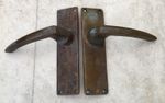 A VINTAGE PAIR OF MILITARY ISSUE SOLID BRASS DOOR HANDLES - BROAD ARROW MARK