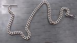 AN ANTIQUE LONG STERLING SILVER POCKET WATCH CHAIN, 39 GRAMS.