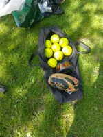 softball equipment, including a bag, balls fielding glove,  protective goggles .