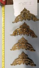 A NEAR SET OF FOUR LONGCASE/GRANDFATHER CLOCK CHERUB HEAD SPANDRELS (TYPE I)