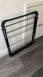 Foldable black 3-tier metal clothes airer collapses completely flat for compact,