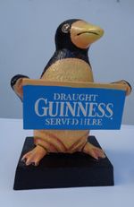 Draught 6 1/2" GUINNESS SOLD HERE Advertising Sign held by a Penquin