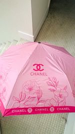 CHANEL Pink Floral Logo Compact Folding Umbrella with Carry Sleeve