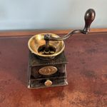 A RARE ANTIQUE COFFEE GRINDER, CLARK’S IMPROVED CAST IRON & BRASS CIRCA-1890.