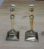 A pair of early 20th century brass pusher candlesticks 9 inches high
