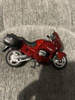 collectible diecast model Replica of a red BMW R1100RT motorcycle