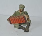 LINEOL  GERMAN OFFICER SITTING PLAYING CONCERTINA.000