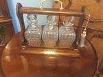 A QUALITY GENTLEMEN’S  ANTIQUE OAK CASED,THREE BOTTLE TANTALUS  CIRCA 1910.