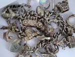 Vintage heavy solid silver charm bracelet &many curious silver charms inc moving