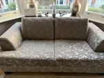 2 seater sofa in grey with elegance velvety touch. Wooden frame and legs