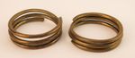 Pair of Naga (Burma) incised coiled brass armband bracelets. Provenance