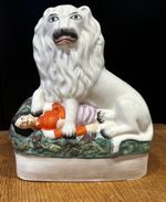19thC Staffordshire figure depicting the British Lion victory over Napoleon III