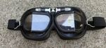 Vintage-style leather aviation or motorcycle goggles.