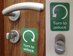 TURN TO UNLOCK ADHESIVE STICKER SIGN. Anticlockwise/clockwise. For doors/knobs