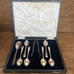 Six small One Large coffee/tea spoons and one pair of sugar tongs in Case