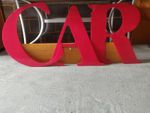 Variety of large red perspex alphabetic letters