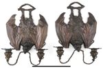 A pair of Art Nouveau style patinated bronze bat gothic design wall sconces