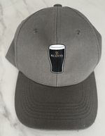 A New Guinness Grey Baseball Cap With A Printed Guinness Pint.