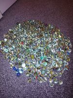Bulk lot of vintage glass marbles With a mix of colours, sizes and styles.