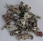 Vintage heavy solid silver charm bracelet &many curious silver charms inc moving