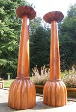 A LARGE PAIR OF  CARVED WOODEN CHURCH PRICKET CANDLESTICKS