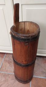 Antique wooden butter churn, tall thin coopered umbrella stick stand, iron bands