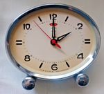 POLARIS Chinese made oval shaped metal alarm clock in a light blue colour case.