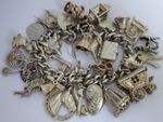 Vintage heavy solid silver charm bracelet &many curious silver charms inc moving