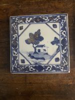 An 18th century Chinese Blue And White tile, featuring A homestead and a tree