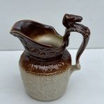 Style Of Arthur Wood England Embossed Brown Ceramic Pitcher With Horse Handle.