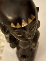 Hard Wood Craving Of Boy Monkeys Sitting On Large Turtle