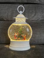 LED light-up Christmas water lantern spinner, functions as automated snow globe.