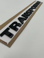Transporter  Gloss Black Rear Letters Badge