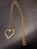 18" Gold Chain With A Heart Filled With Several Diamonds. Very Nice Piece. 
