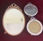 Two antique solid silver photo frames and an antique brass mirror